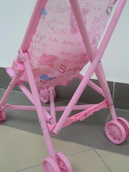 Toy pushchair with doll